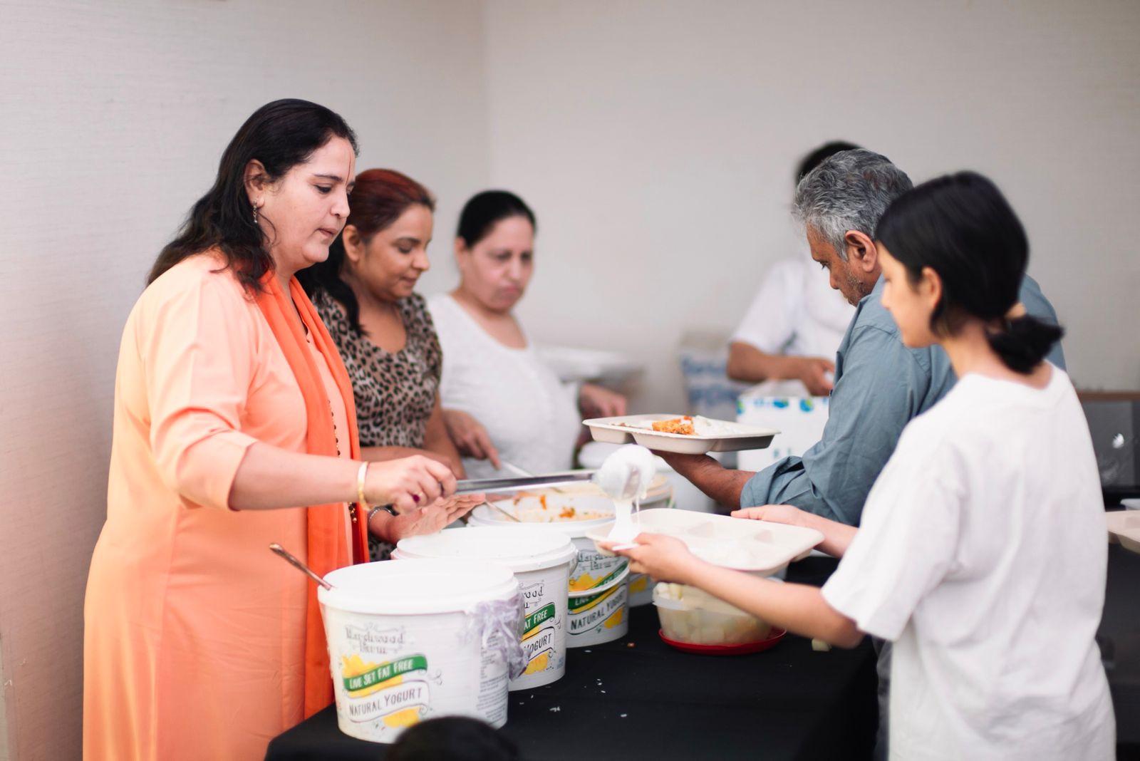 Volunteers serving a shared meal together