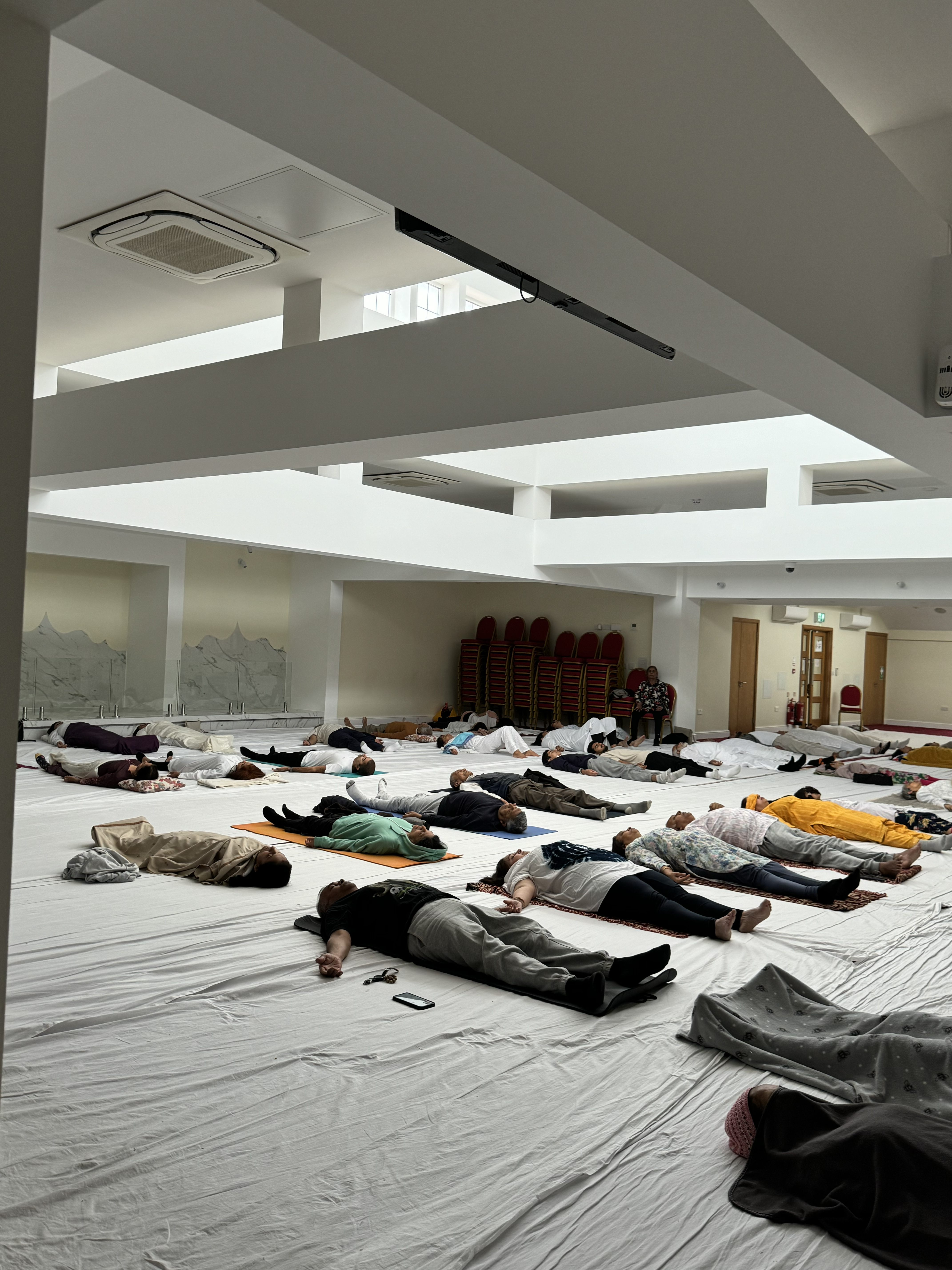 The hall settling into yoga nidra